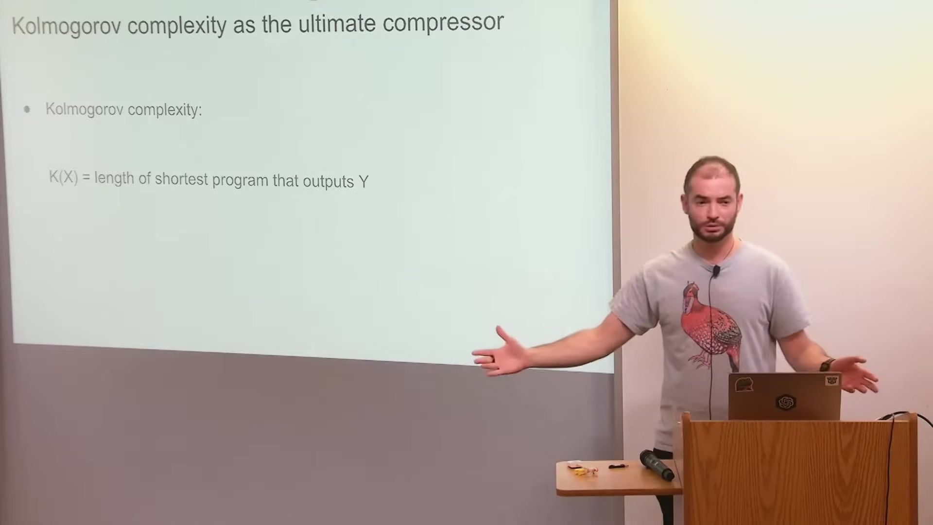 Slide explaining Kolmogorov complexity as the shortest program that outputs a string